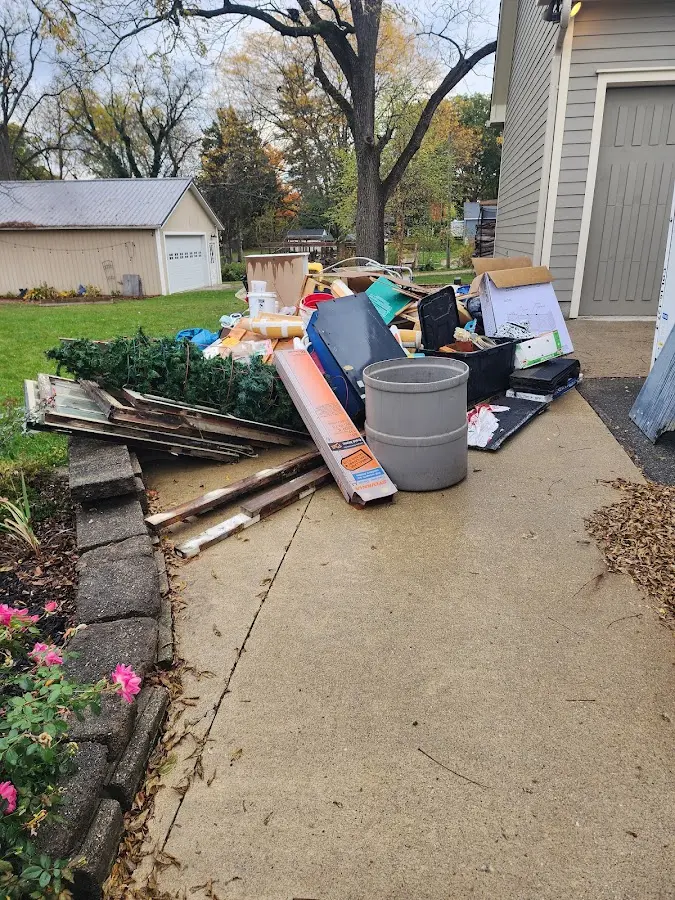 Dumpster being loaded with debris for Estate Cleanout Dumpster Rental in Daytona Beach